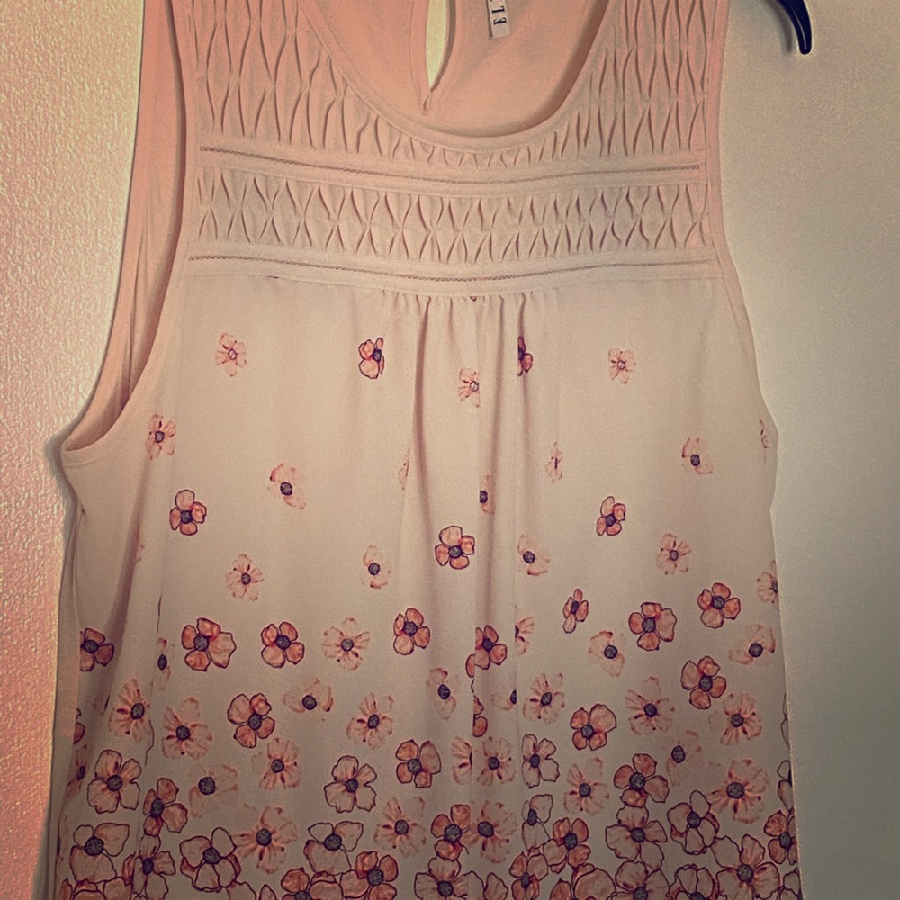 Pink sleeveless blouse.